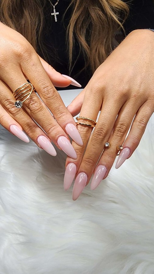 Soft nude manicure with delicate rings