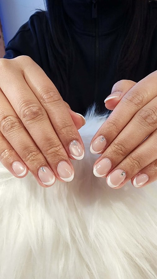 French tip manicure with rhinestone accents