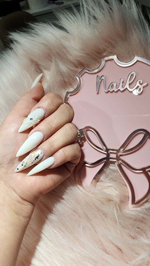 Long white stiletto acrylic nail set with nail art accent